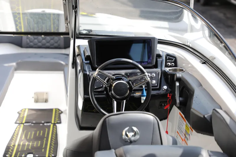 Slide: The Image of 2023 Scarab 255 ID boat cockpit with modern steering and dashboard controls. - 7