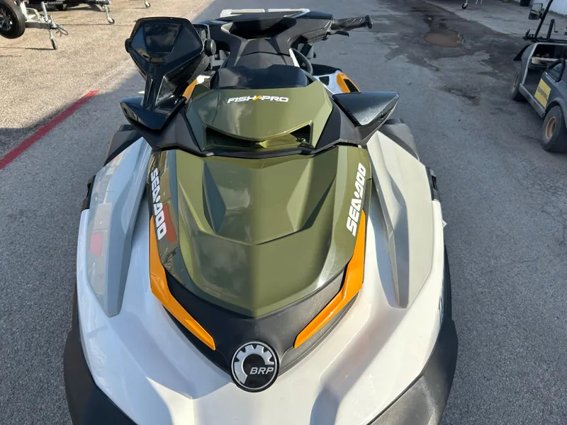 Slide: The Image of 2020 Sea-Doo FISH PRO 170 jet ski, top view, parked on pavement. - 2