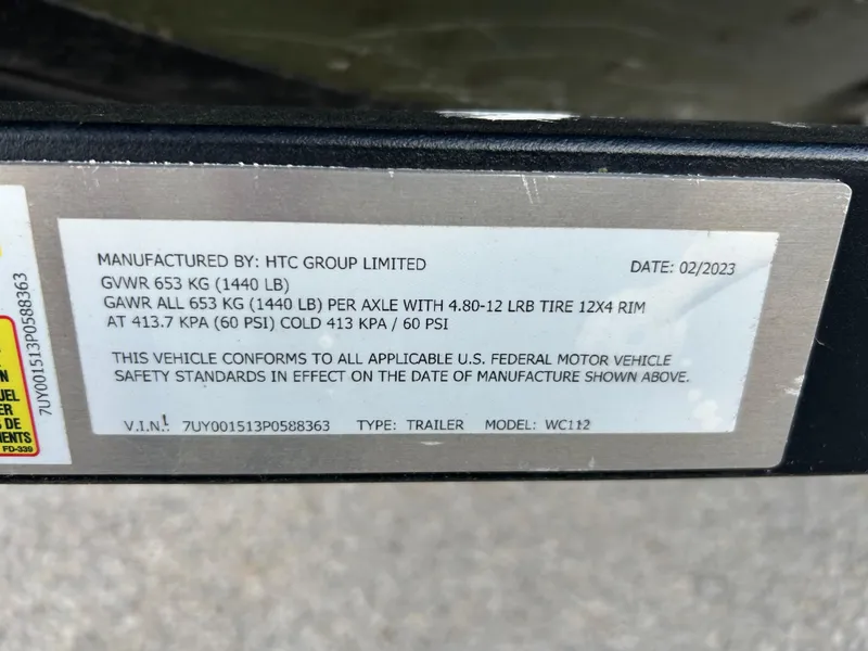 Slide: The Image of Trailer label showing specifications and compliance details, manufactured by HTC Group Limited. - 23
