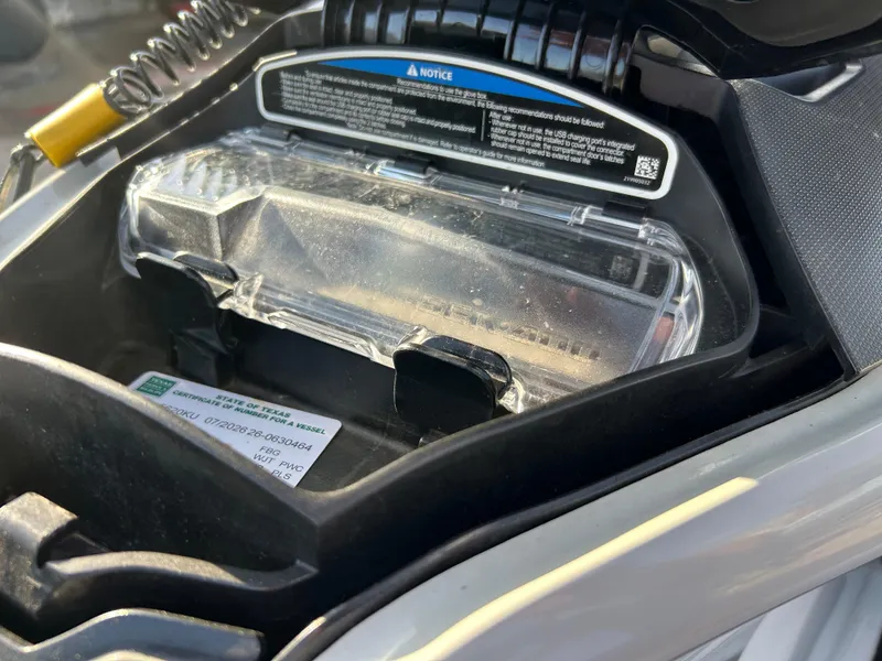 Slide: The Image of 2020 Sea-Doo FISH PRO 170 glove box with Texas vessel certificate visible. - 25