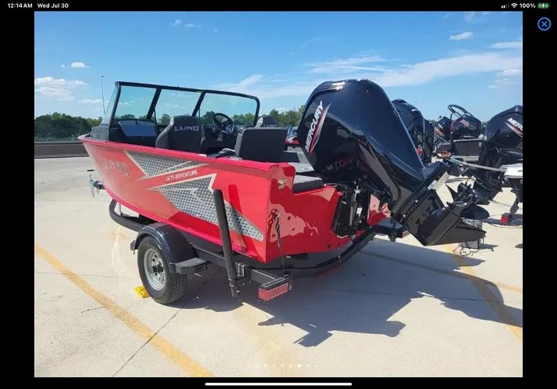 Slide: The Image of 2024 Lund 1675 Adventure Sport boat with Mercury engine, parked on a trailer. - 13