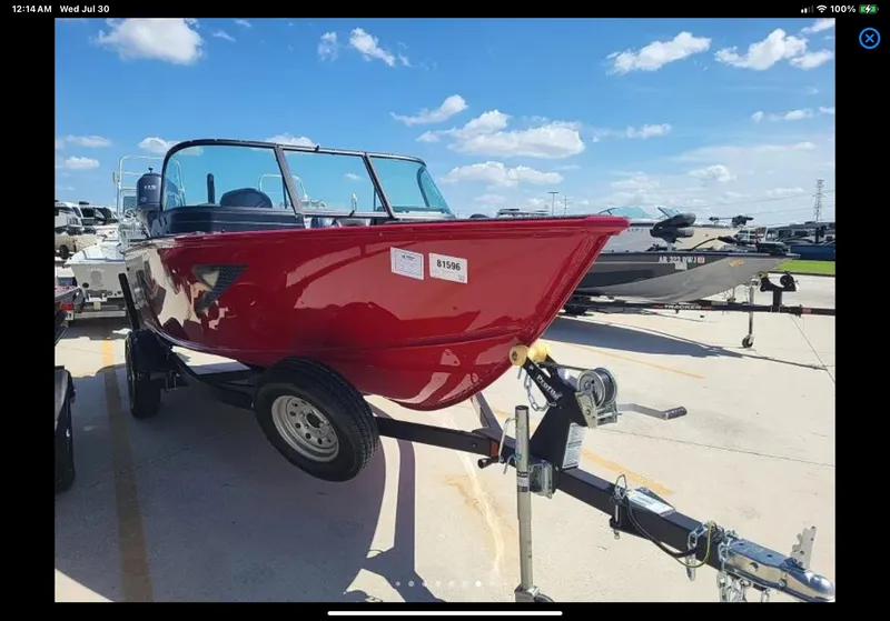 Slide: The Image of 2024 Lund 1675 Adventure Sport boat on trailer, parked outdoors under a clear sky. - 17