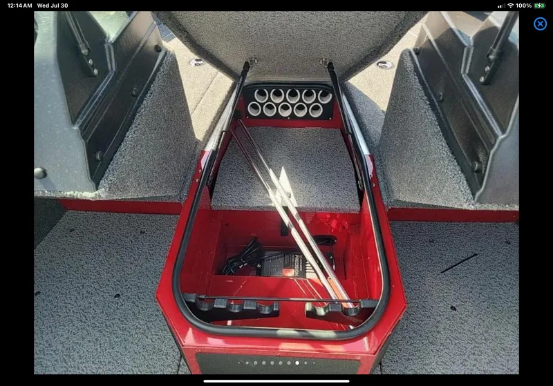 Slide: The Image of 2024 Lund 1675 Adventure Sport boat interior storage compartment with rod holders. - 20
