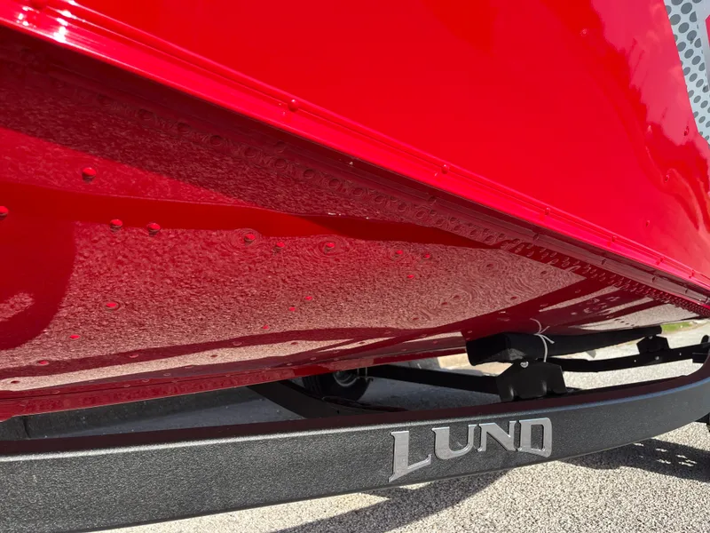 Slide: The Image of 2024 Lund 1675 Adventure Sport boat with vibrant red hull and visible branding. - 26