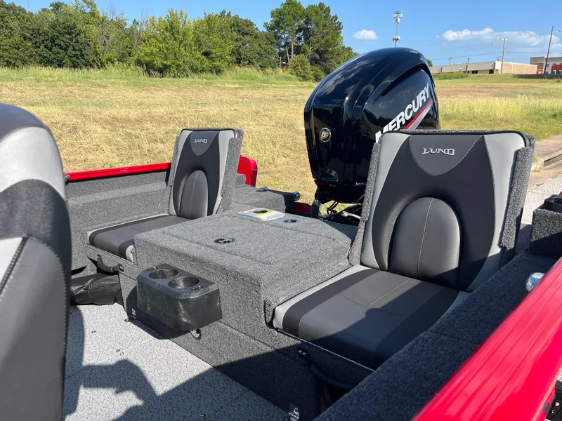 Slide: The Image of 2024 Lund 1675 Adventure Sport boat interior with Mercury engine, featuring comfortable seating. - 29
