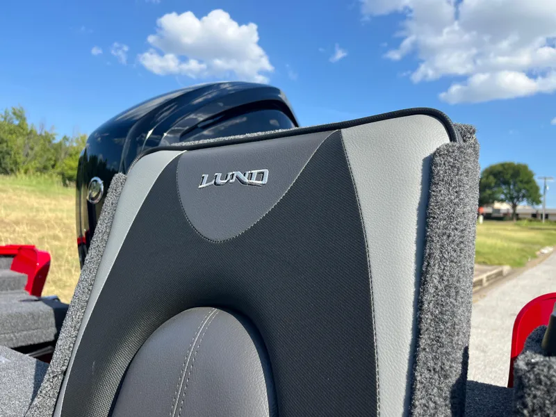 Slide: The Image of 2024 Lund 1675 Adventure Sport boat seat with logo, under a clear blue sky. - 30