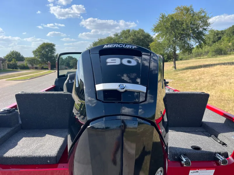 Slide: The Image of 2024 Lund 1675 Adventure Sport boat with Mercury 90 engine, parked outdoors. - 36