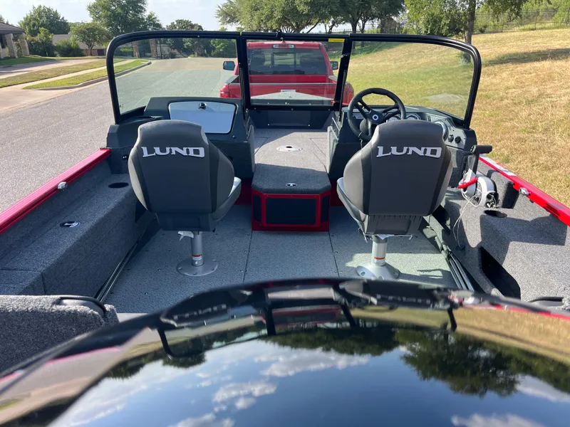 Slide: The Image of 2024 Lund 1675 Adventure Sport boat interior with dual seats and steering console. - 40