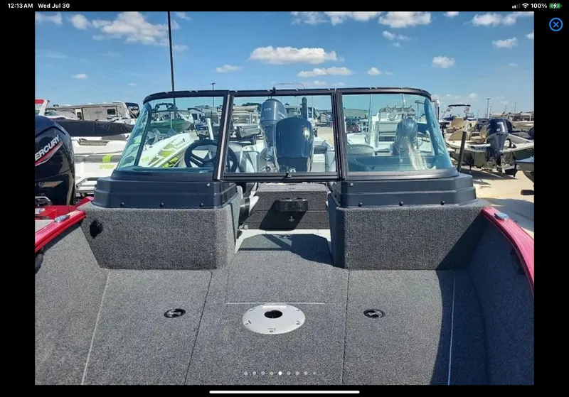 Slide: The Image of 2024 Lund 1675 Adventure Sport boat, interior view with windshield, parked outdoors. - 6