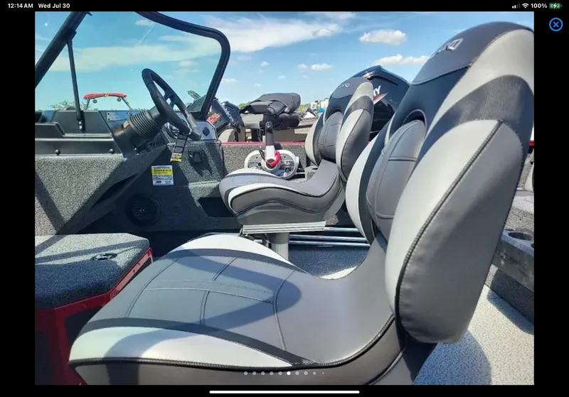 Slide: The Image of 2024 Lund 1675 Adventure Sport boat interior with modern seating and steering wheel. - 7