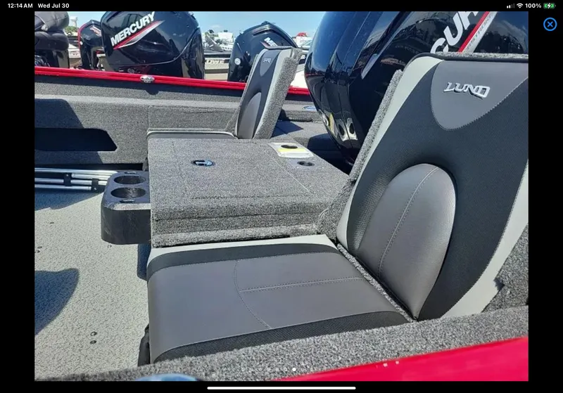 Slide: The Image of 2024 Lund 1675 Adventure Sport boat interior with cushioned seats and Mercury engines. - 8