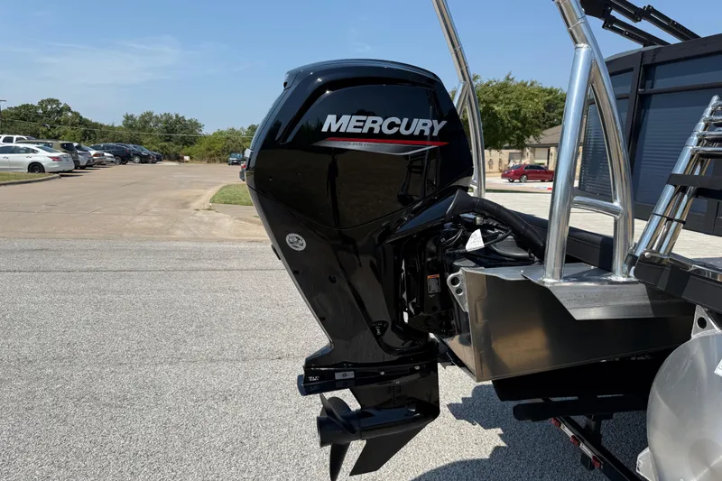 Slide: The Image of Outboard motor on 2025 Flagship E22RF Sport Toon boat, parked in a lot. - 12