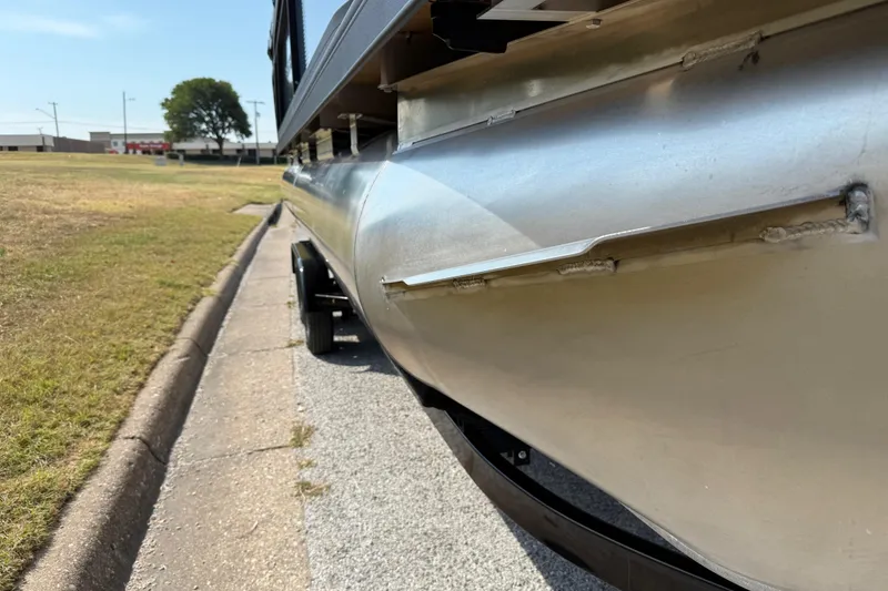 Slide: The Image of 2025 Flagship E22RF Sport Toon pontoon boat on a trailer, side view. - 24