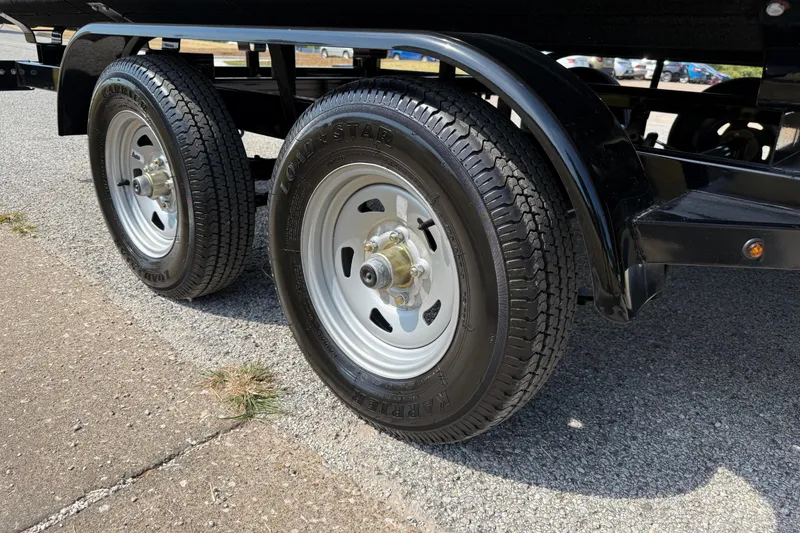 Slide: The Image of 2025 Flagship E22RF Sport Toon trailer wheels on asphalt road. - 26