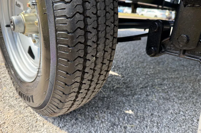 Slide: The Image of Close-up of 2025 Flagship E22RF Sport Toon tire on asphalt surface. - 28