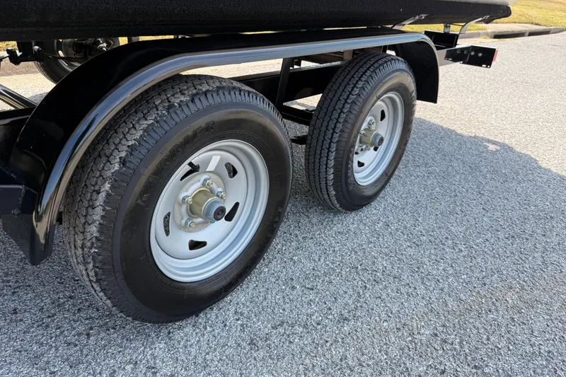 Slide: The Image of Trailer wheels of 2025 Flagship E22RF Sport Toon on asphalt road. - 31