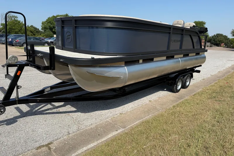 Slide: The Image of 2025 Flagship E22RF Sport Toon pontoon boat on a trailer in a parking lot. - 35