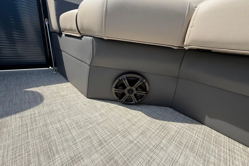Slide: The Image of 2025 Flagship E22RF Sport Toon boat interior with speaker and cushioned seating. - 49