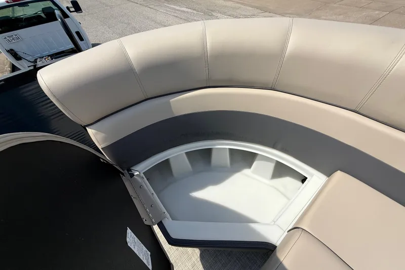 Slide: The Image of 2025 Flagship E22RF Sport Toon boat with beige seating and storage compartment. - 50