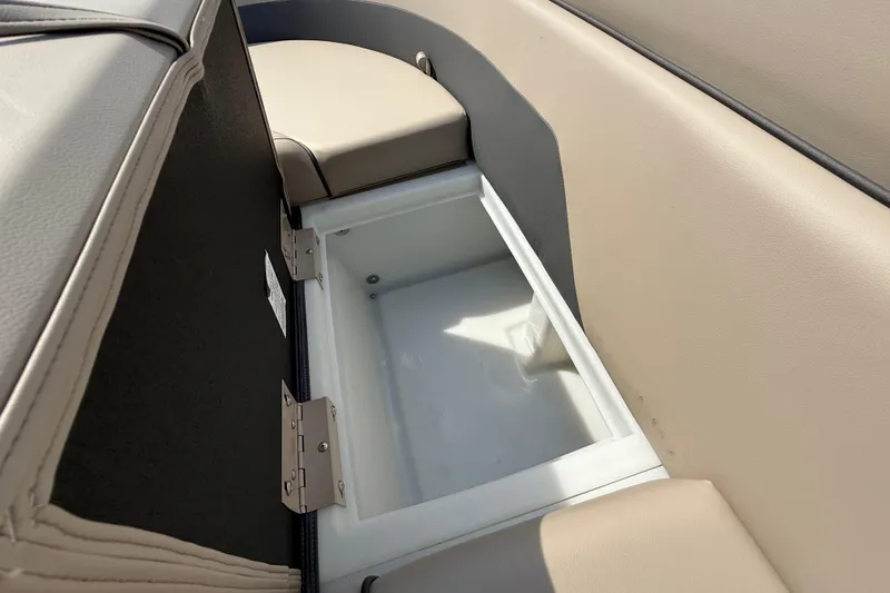 Slide: The Image of 2025 Flagship E22RF Sport Toon boat storage compartment with beige seating. - 52