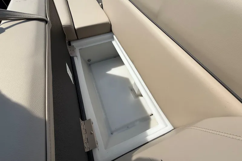 Slide: The Image of 2025 Flagship E22RF Sport Toon boat seat storage compartment, open and empty. - 53