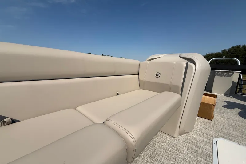 Slide: The Image of 2025 Flagship E22RF Sport Toon boat with beige seating under clear blue sky. - 54