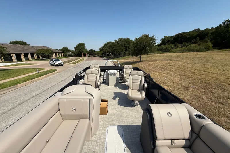 Slide: The Image of 2025 Flagship E22RF Sport Toon pontoon boat with luxurious seating on a sunny day. - 55