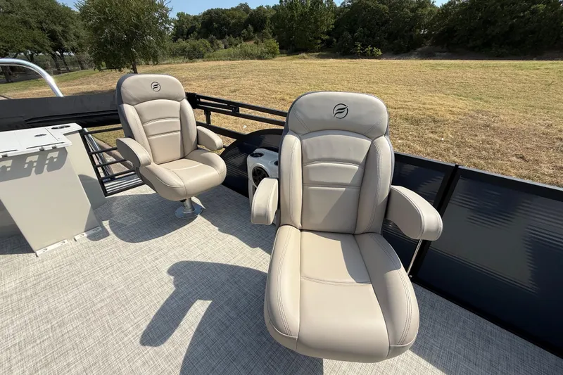 Slide: The Image of Luxurious seating on the 2025 Flagship E22RF Sport Toon pontoon boat, featuring plush armchairs. - 58