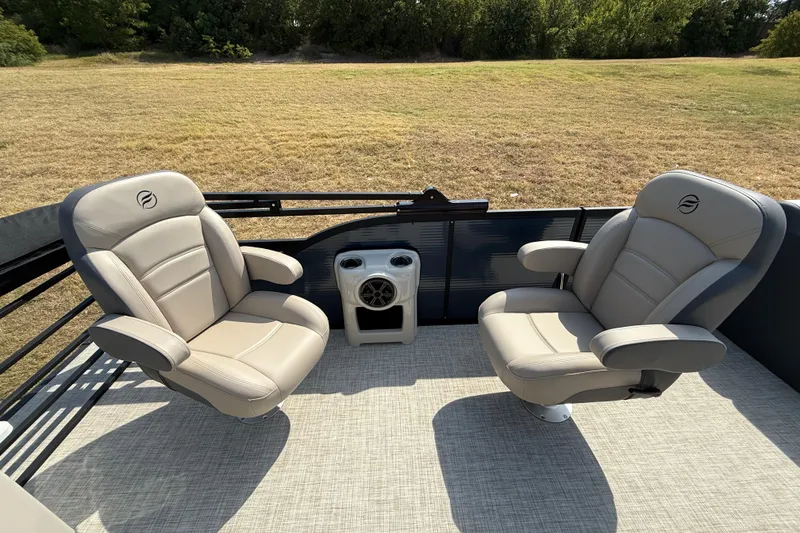 Slide: The Image of 2025 Flagship E22RF Sport Toon boat interior with two beige captain chairs. - 61