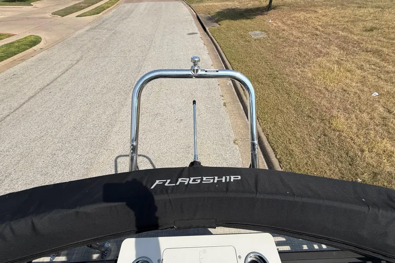 Slide: The Image of 2025 Flagship E22RF Sport Toon boat on a road, featuring a sleek design. - 64