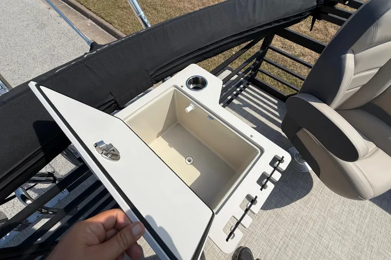 Slide: The Image of 2025 Flagship E22RF Sport Toon boat interior with open storage compartment and seating. - 65