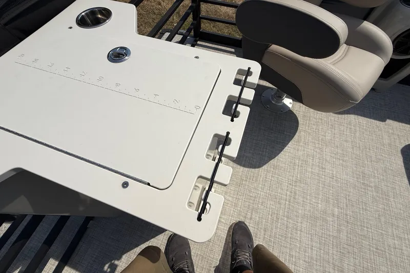 Slide: The Image of 2025 Flagship E22RF Sport Toon boat interior with fishing table and seating. - 66