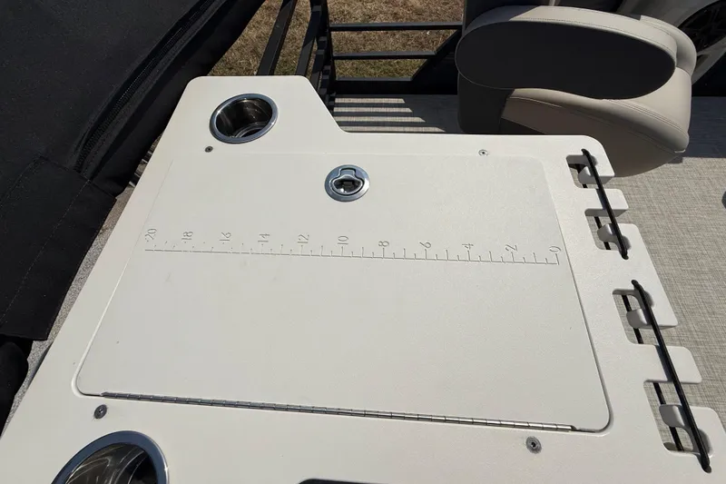 Slide: The Image of 2025 Flagship E22RF Sport Toon boat deck with built-in cup holders and measuring board. - 67