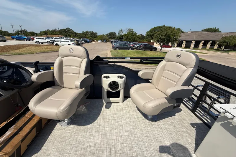Slide: The Image of 2025 Flagship E22RF Sport Toon boat interior with beige captain chairs and speaker system. - 70