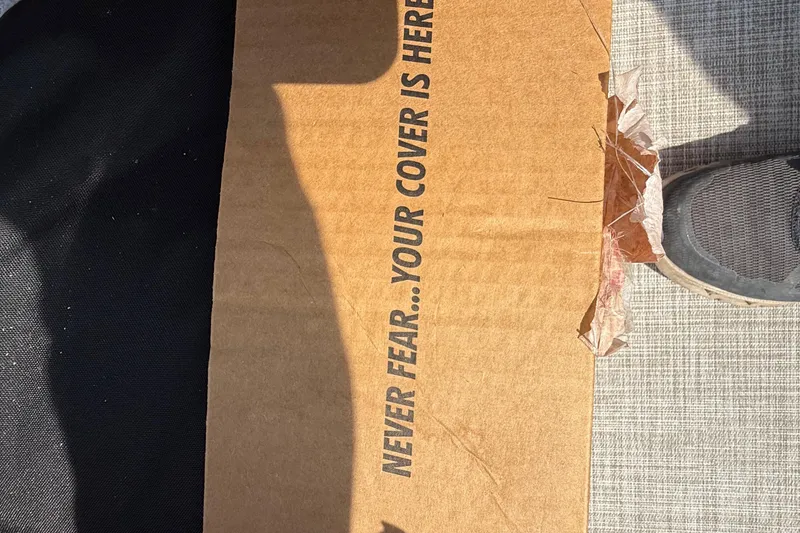 Slide: The Image of Cardboard box with text "Never Fear... Your Cover is Here" beside a shoe. - 72