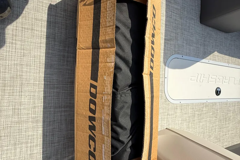 Slide: The Image of Cardboard box on Flagship E22RF Sport Toon 2025 boat deck. - 73