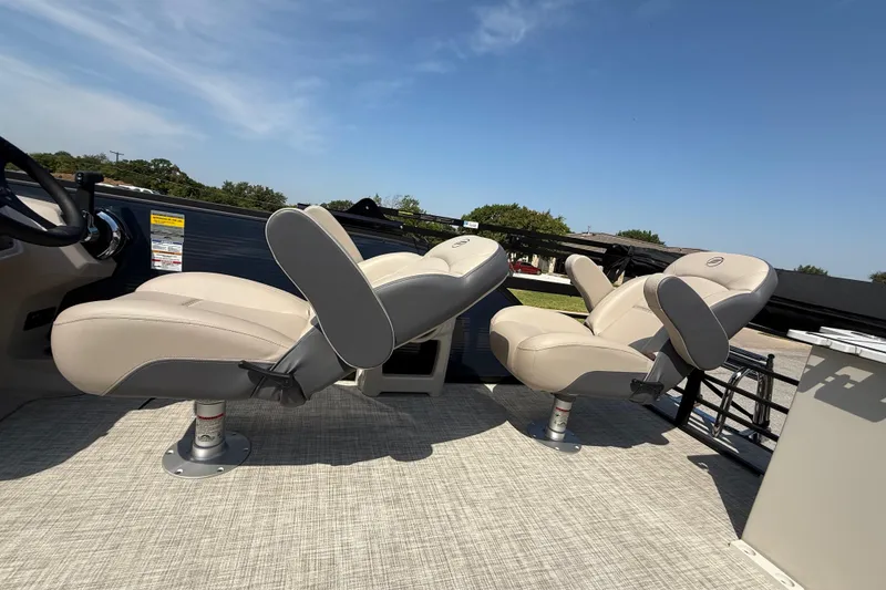 Slide: The Image of 2025 Flagship E22RF Sport Toon boat seats, beige upholstery, outdoor setting, clear sky. - 74