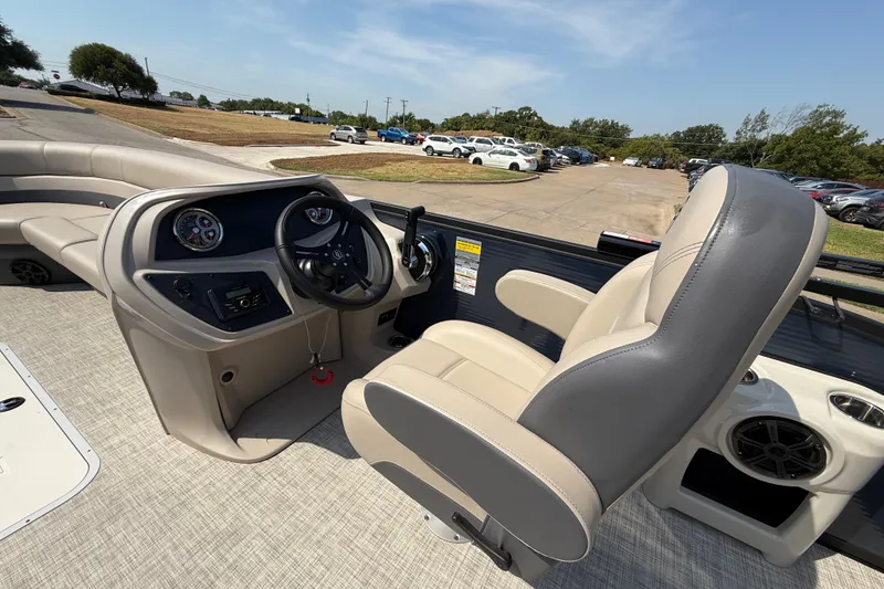 Slide: The Image of 2025 Flagship E22RF Sport Toon boat interior with steering wheel and seating. - 75