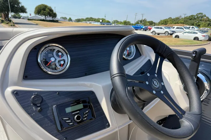 Slide: The Image of Steering console of 2025 Flagship E22RF Sport Toon boat with gauges and controls. - 76