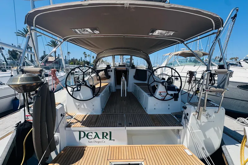 The Image of 2023 Jeanneau 380 sailboat docked in San Diego marina, featuring dual steering wheels. - 0
