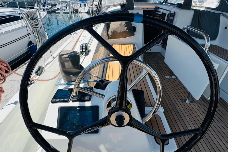 Slide: The Image of Steering wheel of 2023 Jeanneau 380 sailboat, docked at marina. - 15