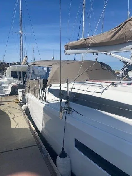 Slide: The Image of 2023 Jeanneau 380 sailboat docked at marina under clear blue sky. - 29