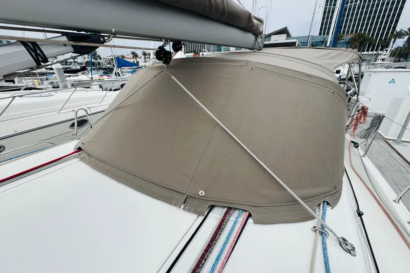 Slide: The Image of 2023 Jeanneau 380 sailboat with beige canvas cover at marina. - 37