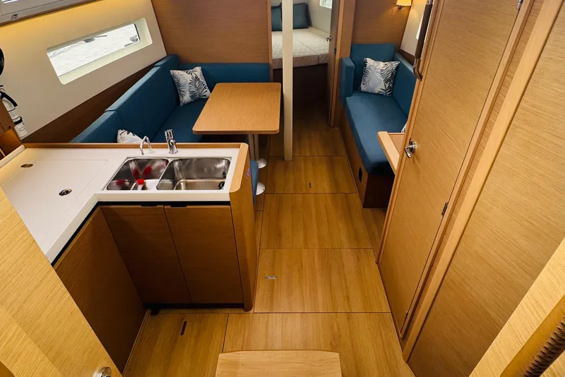 Slide: The Image of Interior of 2023 Jeanneau 380 yacht with modern kitchen and cozy seating area. - 39