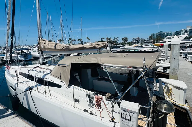 Slide: The Image of 2023 Jeanneau 380 sailboat docked at marina under clear blue sky. - 4