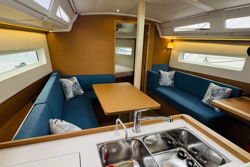 Slide: The Image of Modern interior of 2023 Jeanneau 380 yacht with blue seating and wooden accents. - 45