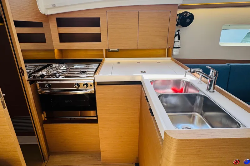 Slide: The Image of Modern kitchen in 2023 Jeanneau 380 yacht with stove, sink, and wooden cabinetry. - 46