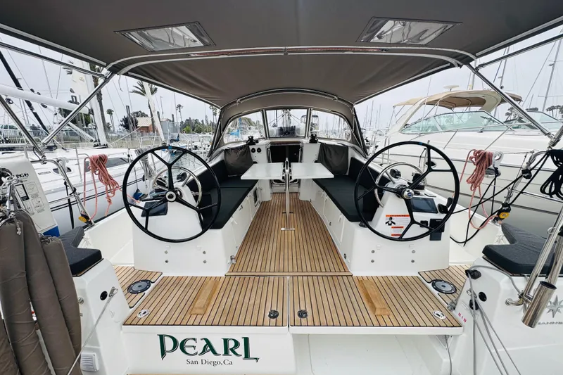 Slide: The Image of 2023 Jeanneau 380 sailboat cockpit with dual steering wheels, docked in San Diego. - 5