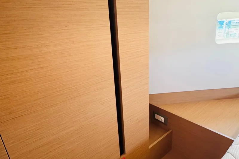 Slide: The Image of 2023 Jeanneau 380 interior with wooden finish and small window. - 59