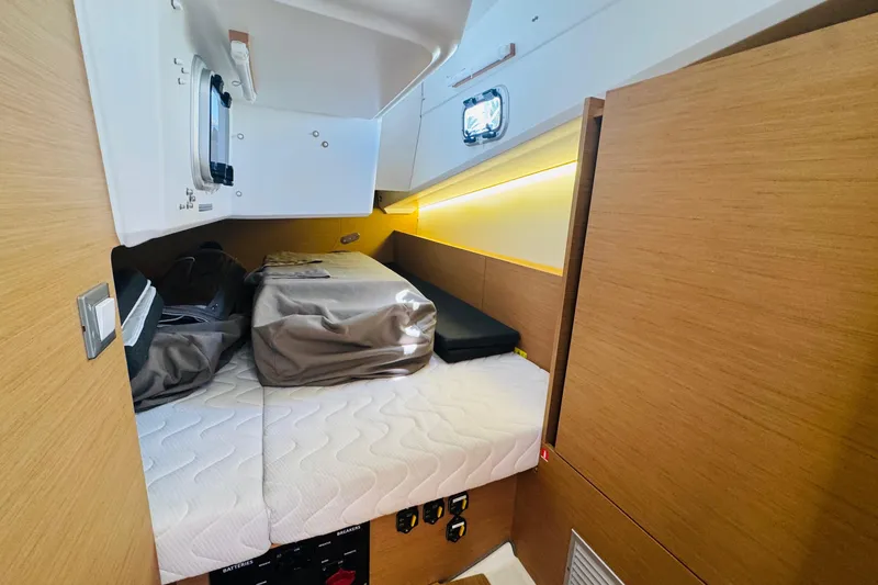 Slide: The Image of Cozy cabin interior of 2023 Jeanneau 380 yacht with modern wood finish and bedding. - 65